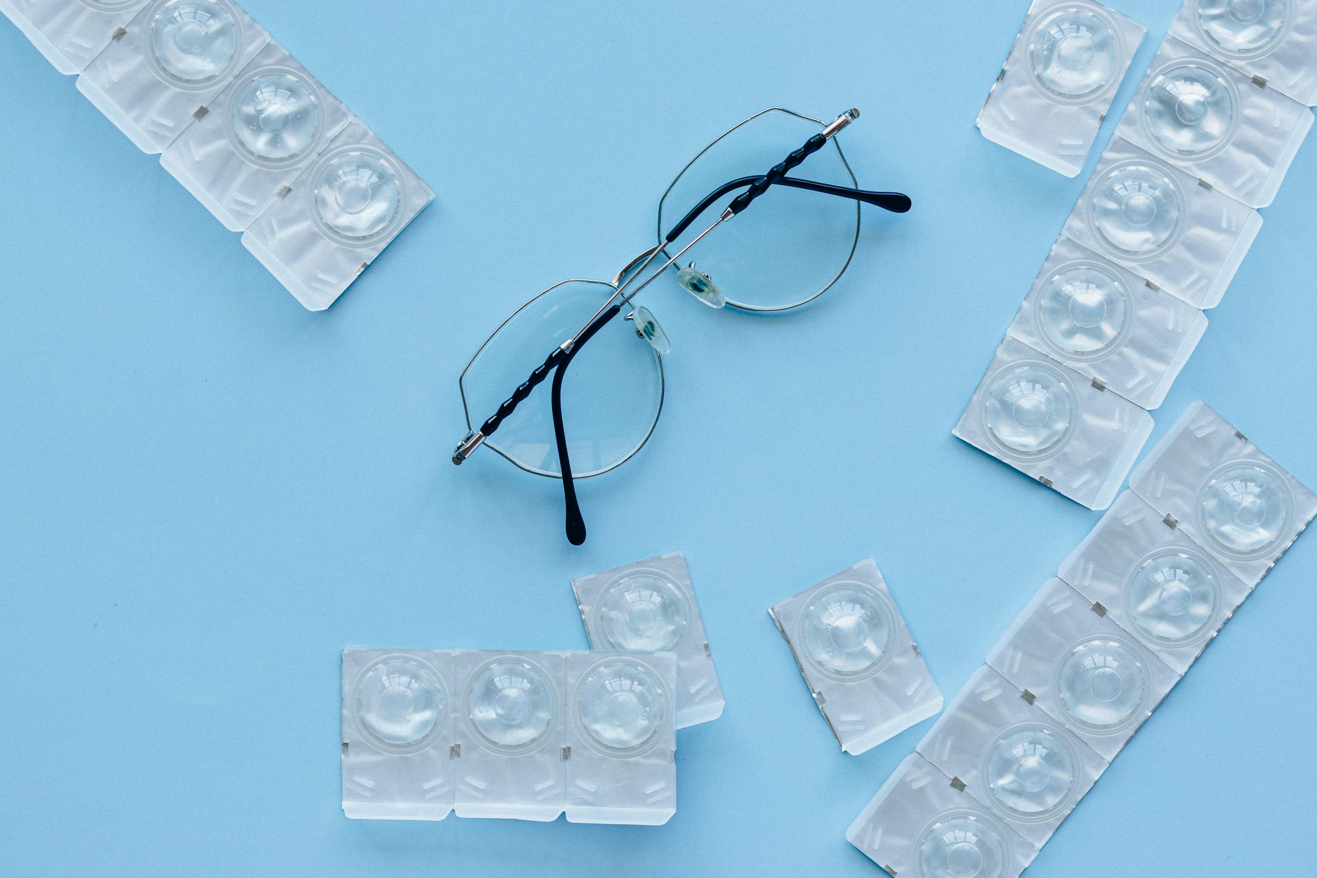 Black Framed Eyeglasses on Blue Table